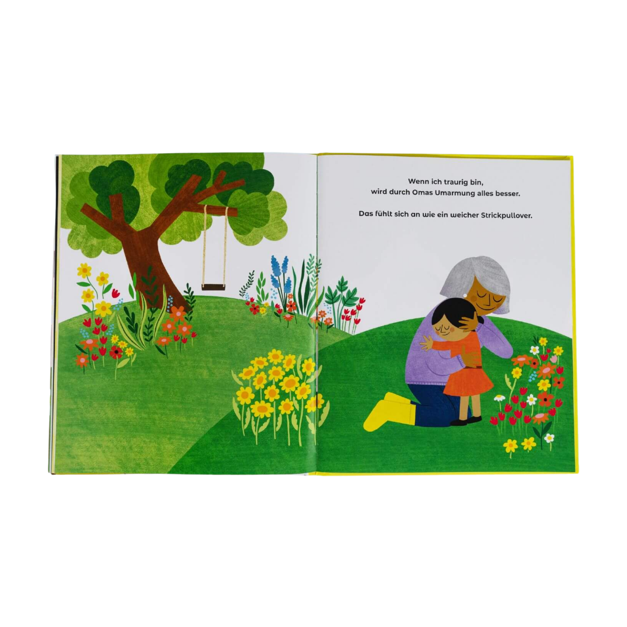 Im illustrierten Kinderbuch „Manchmal bin ich alles, was ich brauche“ von Juliana Perdomo tröstet eine ältere Person ein Kind auf einer bunten Wiese mit Blumen. Im Hintergrund stehen ein Baum mit Schaukel sowie Text auf der Seite.