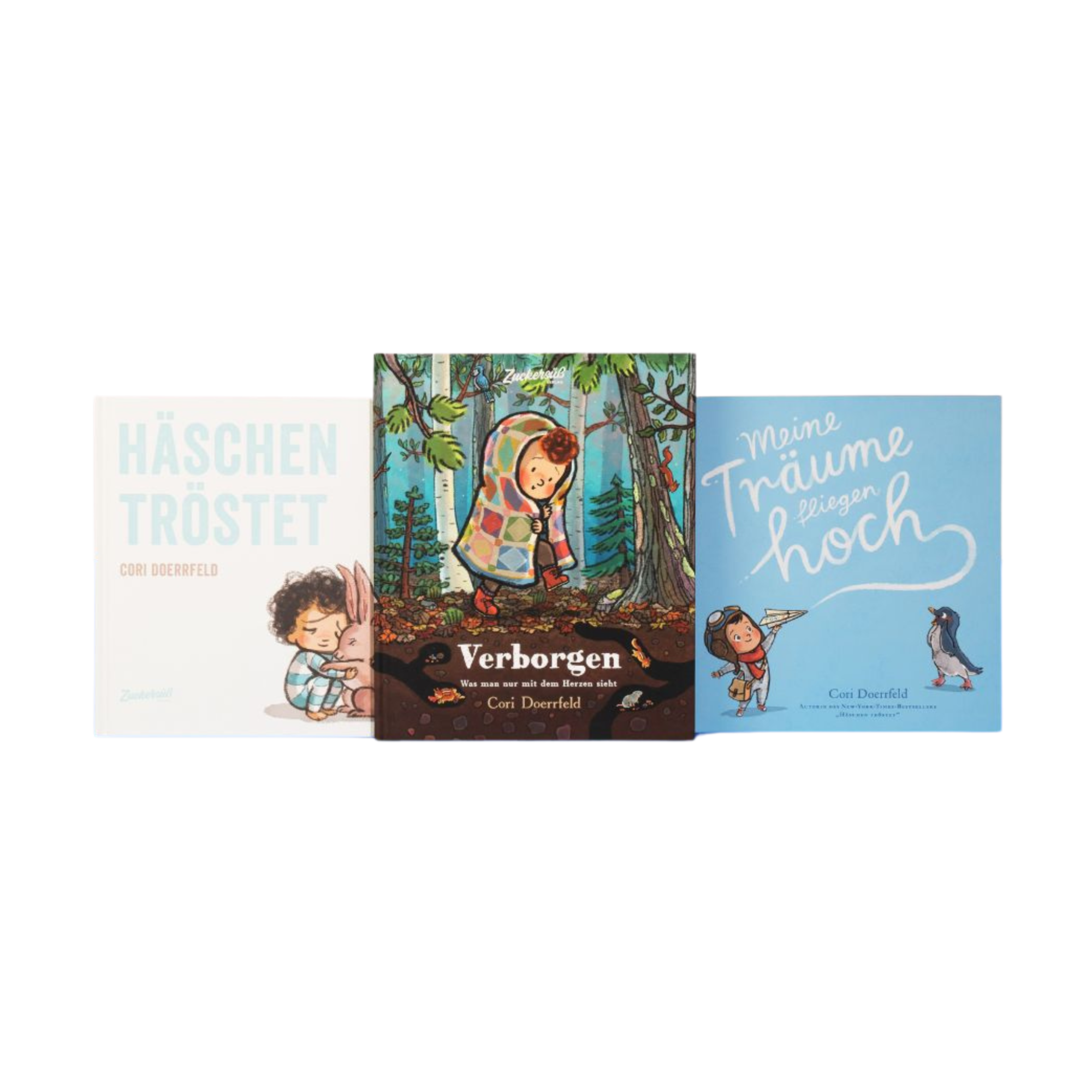 Das Bücherpaket „Best of Cori Doerrfeld“ vom Zuckersüß Verlag zeigt drei aufrecht stehende Kinderbücher. Links das Buch "Häschen tröstet" mit einem Kind, das ein Häschen umarmt. In der Mitte das Buch "Verborgen", Was man nur mit dem Herzen sieht mit einem Kind im Wald unter buntem Patchwork-Mantel. Rechts das Buch "Meine Träume fliegen hoch" mit einem Kind, das einen Papierflieger hält, neben einem Pinguin auf hellblauem Cover.